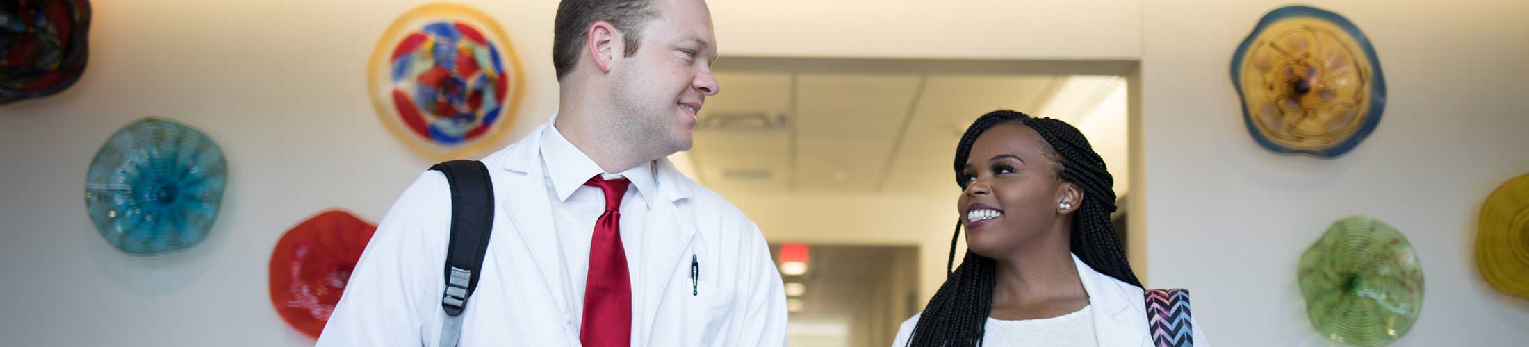 Two Physician Assistant Studies student walking in the Allied Health building.