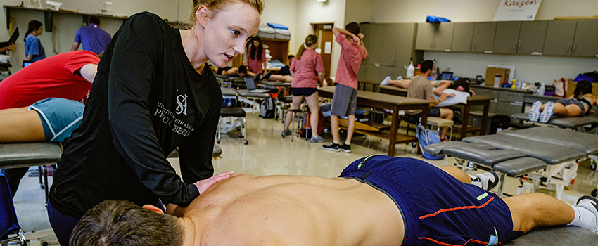 Image of students in PT lab.