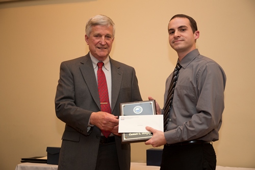 Dr. Bill Williams presents an Outstanding Senior Award to Damian Bonifay.