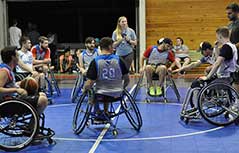 People playing wheelchair basketball.