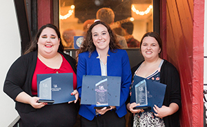 Three female students with awards.