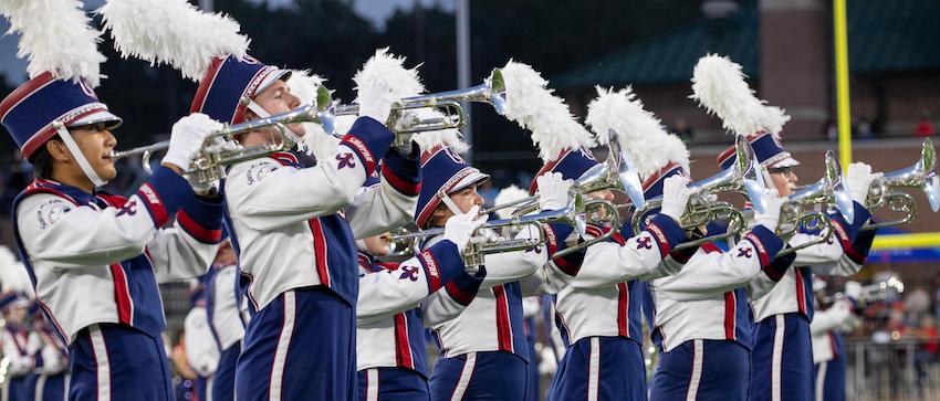 Band performing at game cheering.