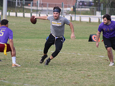 Students playing flag football on campus.