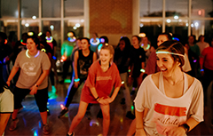 Zumba class dancing wearing glow necklaces