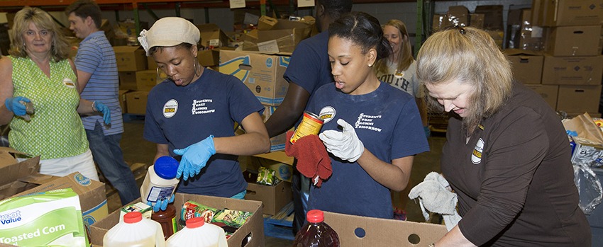 Alumni packing food boxes