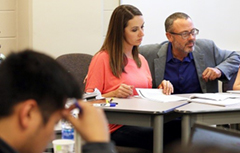 Student working with professor in class