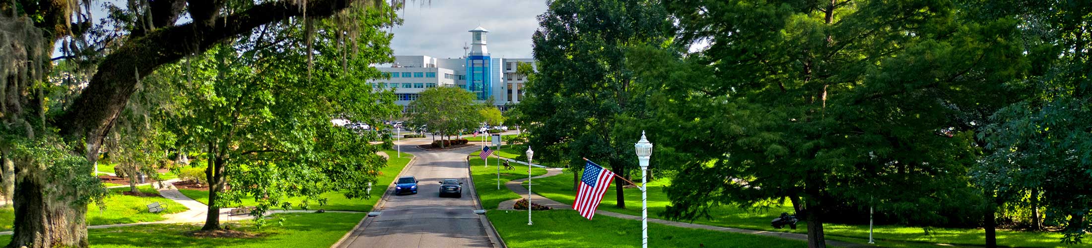 View of USA Medical with cars driving on the street in front of it.