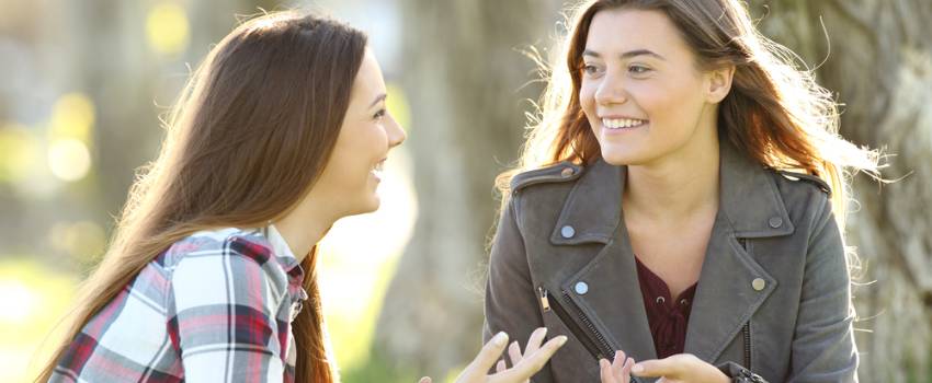 Two girls sitting talking