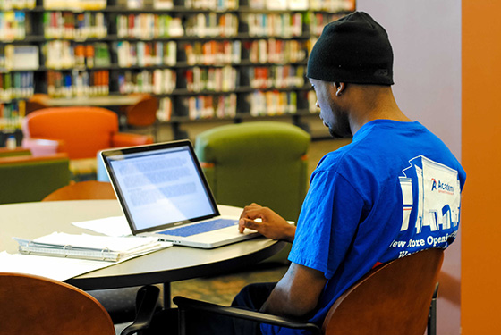 Student smiling looking at laptop