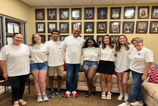 Students smiling in SGA office.