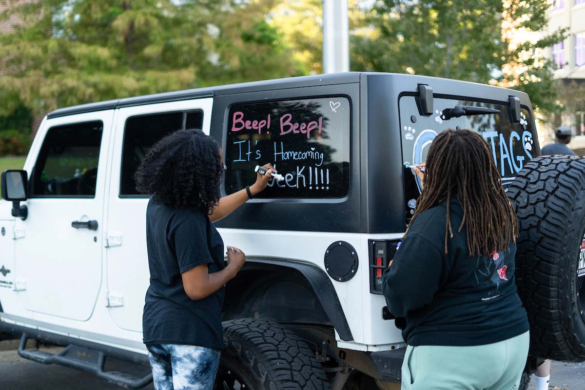 Students decorating car for homecoming week Students decorating car for homecoming week