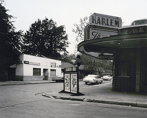 Black and white photo of the exterior of the Harlem Theater